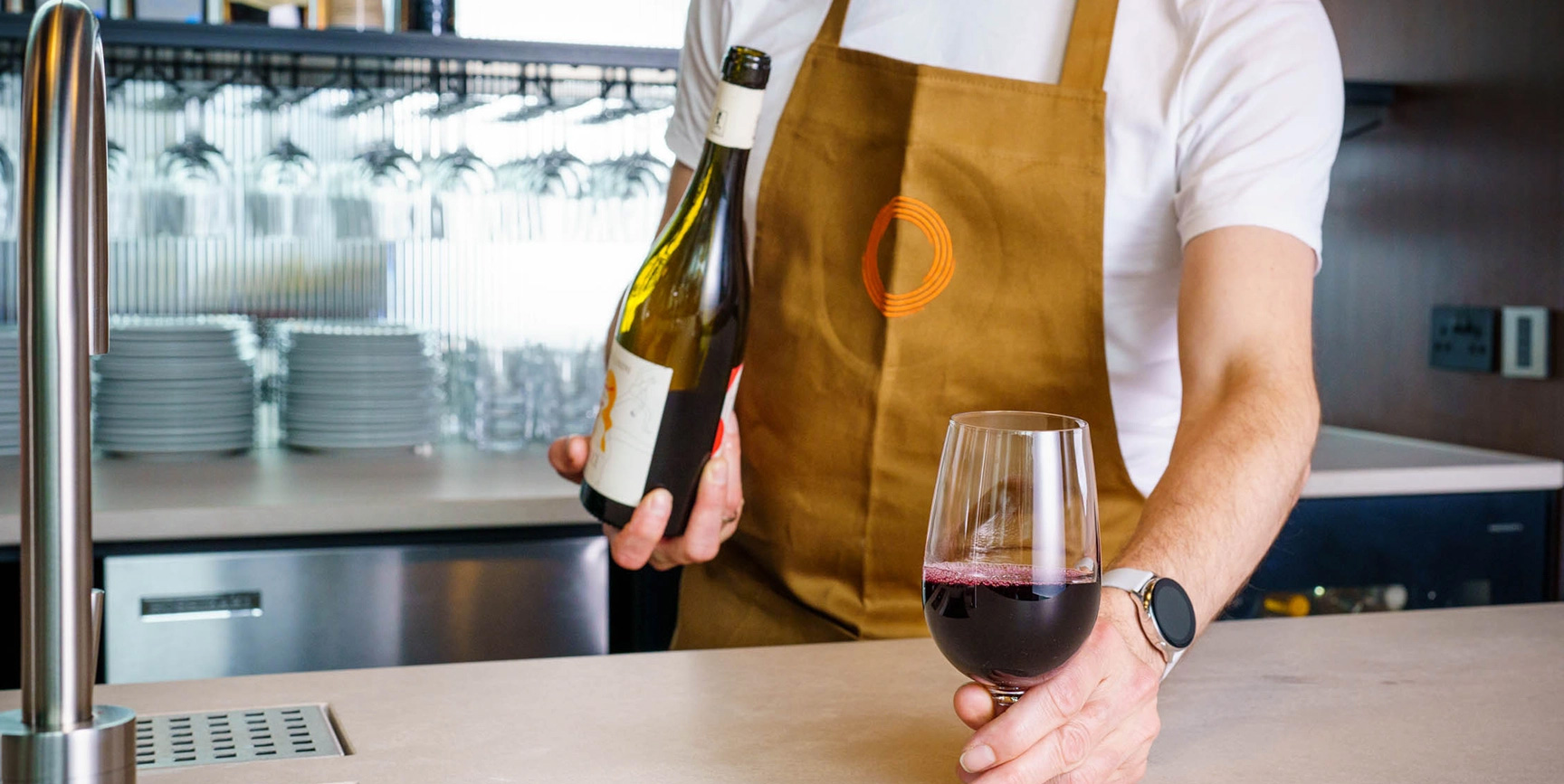 Bartender serving ATOMECA red wine