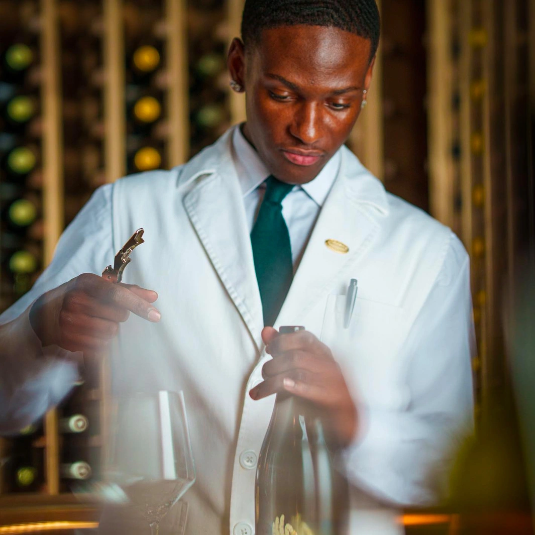 STERLING bar staff opening bottle of wine